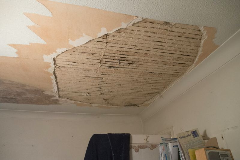Room with ceiling materials removed after water damage